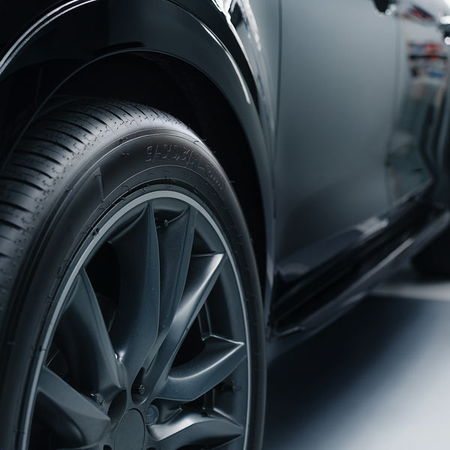 Clean black tire and wheel illustrating AutoBrite Atomic Tire Cleaner use