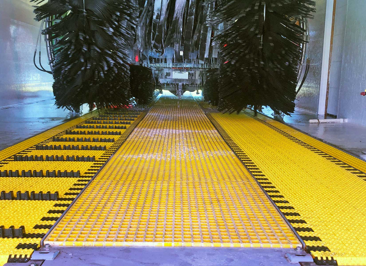 Close-up of AutoBrite dual belt conveyor inside a car wash