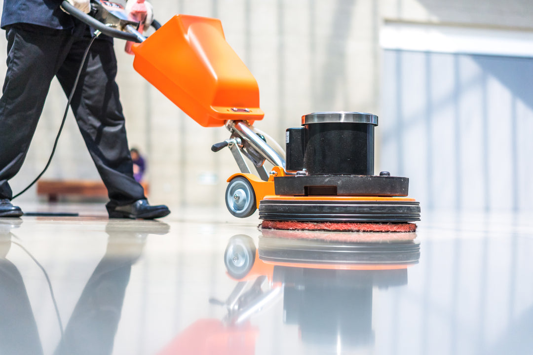 Industrial floor being cleaned with a floor scrubber