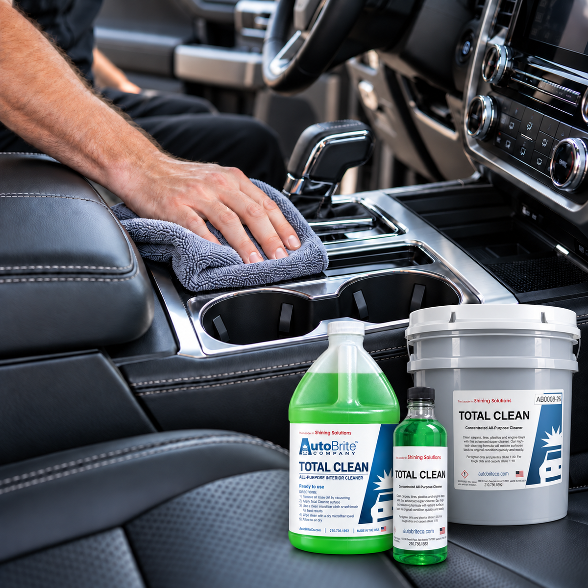 AutoBrite Total Clean interior cleaner in 16 oz, 1 gallon, and 5 gallon sizes with a vehicle center console being cleaned